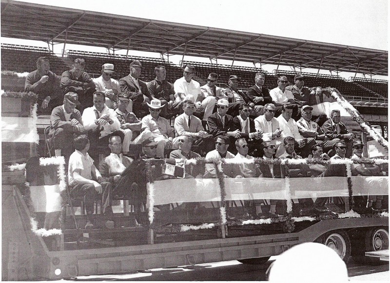 Dave MacDonald and Eddie Sachs seated next to one another in 1964 Indy 500 drivers photo